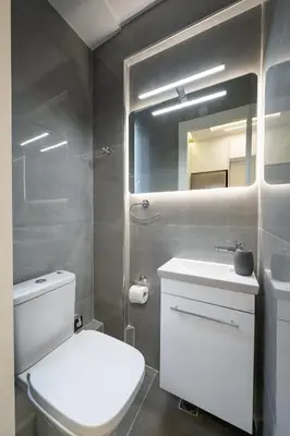 a bathroom with a toilet and a sink and a mirror at Acropolis Cozy Apartments in Athens