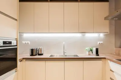a kitchen with white cabinets and a sink at Stunning 2BR Apartment in Lycabettus by UPSTREET in Athens