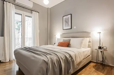 a bedroom with a large bed and a window at Stunning 2BR Apartment in Lycabettus by UPSTREET in Athens