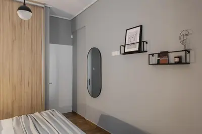 a room with a bed and a mirror on the wall at Stunning 2BR Apartment in Lycabettus by UPSTREET in Athens