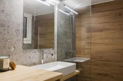 a bathroom with a white sink and a glass shower at Stunning 2BR Apartment in Lycabettus by UPSTREET in Athens