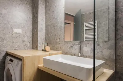 a bathroom with a sink and a washing machine at Stunning 2BR Apartment in Lycabettus by UPSTREET in Athens