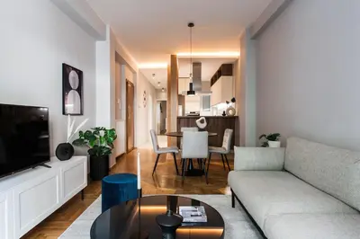 a living room with a couch and a table at Stunning 2BR Apartment in Lycabettus by UPSTREET in Athens