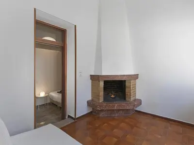 a living room with a brick fireplace in a room at Elegant, affordable apartment with a fireplace in Athens