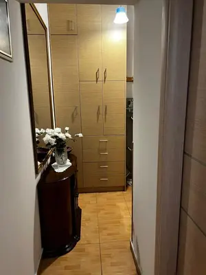 a hallway with a mirror and a vase of flowers at Athens Room in Athens