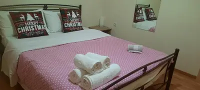 a bedroom with a bed with towels on it at Livia's Room To Ampelokipi metro Airport line in Athens