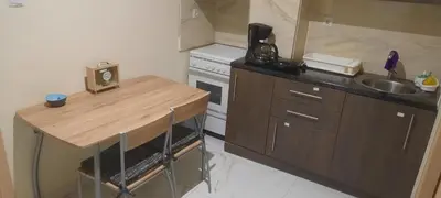 a small kitchen with a wooden counter and a sink at Livia's Room To Ampelokipi metro Airport line in Athens