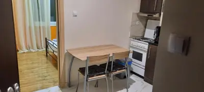 a small kitchen with a small table and a stove at Livia's Room To Ampelokipi metro Airport line in Athens