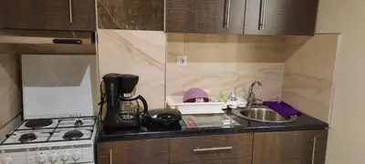 a kitchen counter with a sink and a stove at Livia's Room To Ampelokipi metro Airport line in Athens