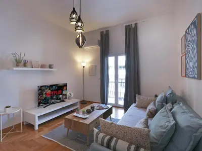 a living room with a couch and a table at Beautiful Athenian apartment next to the center in Athens