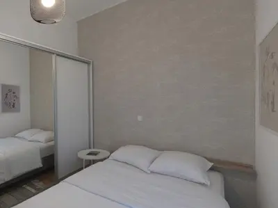 a bedroom with two beds and a wall at Beautiful Athenian apartment next to the center in Athens