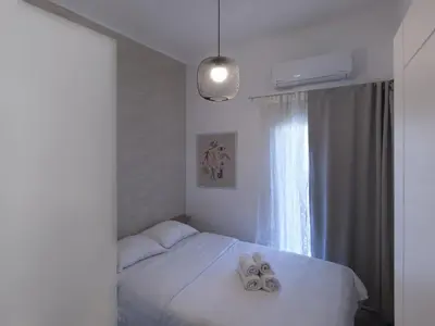 a bedroom with a bed with two towels on it at Beautiful Athenian apartment next to the center in Athens