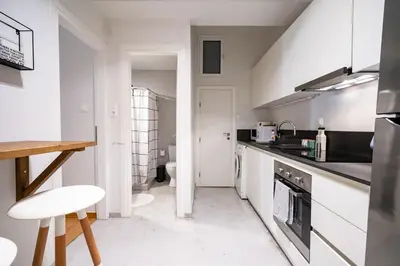 a white kitchen with a sink and a stove at Athens-center 1 bedroom 2 persons apt by MPS in Athens