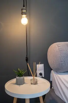a table with a lamp on it next to a bed at Athens-center 1 bedroom 2 persons apt by MPS in Athens