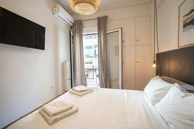 a bedroom with a white bed with two towels on it at Athens-center 1 bedroom 2 persons apt by MPS in Athens