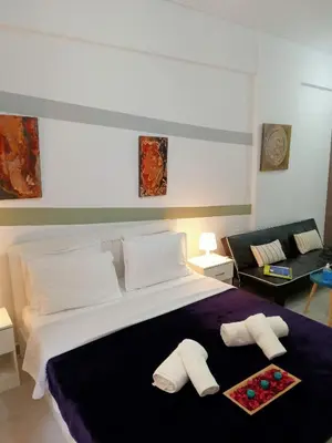 a bedroom with a large bed with two pillows at Cozy spot apt next to metro station . in Athens