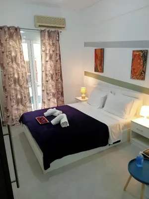 a bedroom with a large bed with two towels on it at Cozy spot apt next to metro station . in Athens