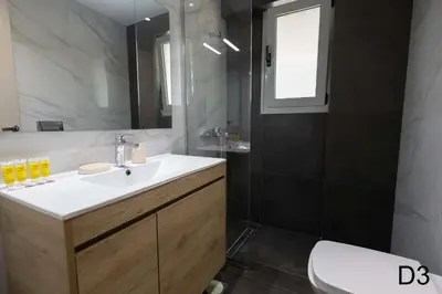 a bathroom with a sink and a mirror at Sea view apartments in Alimos region in Athens
