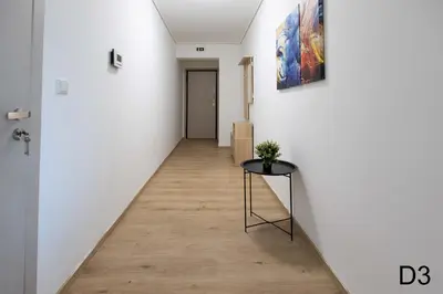 a hallway with a table and a painting on the wall at Sea view apartments in Alimos region in Athens