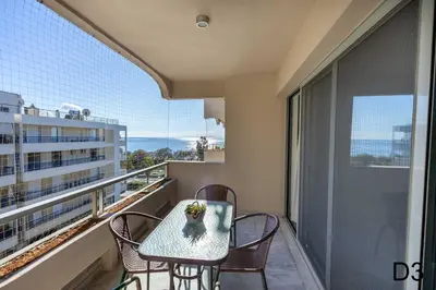 a balcony with a table and chairs on a balcony at Sea view apartments in Alimos region in Athens