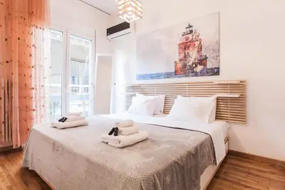 a bedroom with a large bed with towels on it at Plaka's Arch Studio in Athens
