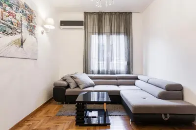 a living room with a couch and a table at Plaka's Arch Studio in Athens