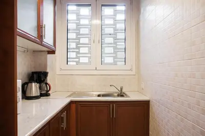 a kitchen with a sink and a window at Plaka's Arch Studio in Athens