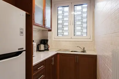 a small kitchen with a sink and a window at Plaka's Arch Studio in Athens