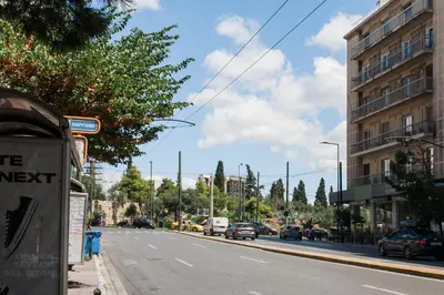 a street with cars parked on the side of the road at Plaka's Arch Studio in Athens