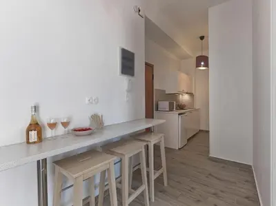 a kitchen with a counter and some wine glasses at Beautiful Athenian apartment with terrace in Athens