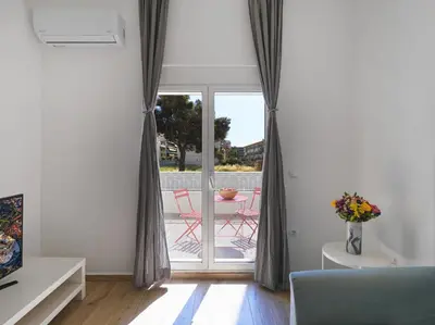 a living room with a sliding glass door with a patio at Beautiful Athenian apartment with terrace in Athens