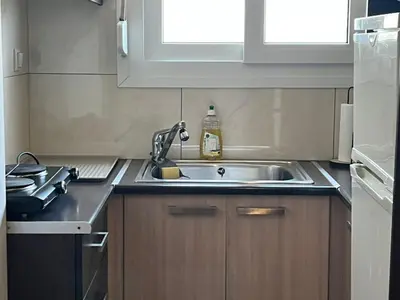 a kitchen with a sink and a stove at Athens Taratsaki in Athens