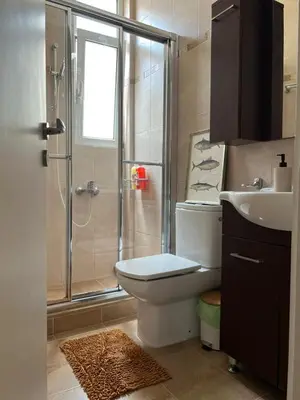 a bathroom with a shower and a toilet and a sink at Athens Taratsaki in Athens
