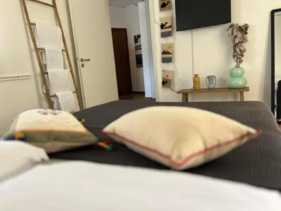 a bedroom with a bed with two pillows on it at Athens Taratsaki in Athens