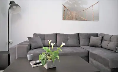 a living room with a gray couch and a table at Lovely apartment in the center of Athens. in Athens