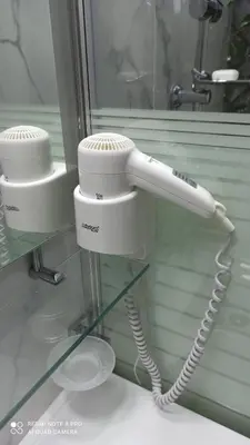 a white phone is hanging on a wall at Lovely apartment in the center of Athens. in Athens