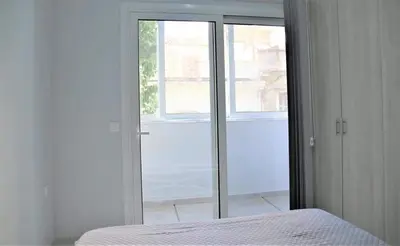 a bedroom with a bed and a sliding glass door at Lovely apartment in the center of Athens. in Athens
