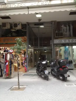 two scooters parked in front of a store at Lovely apartment in the center of Athens. in Athens