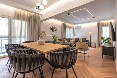a living room with a table and chairs at Phaedrus Living Luxury Penthouse Ploutarchou in Athens