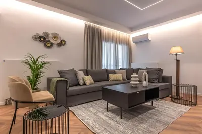a living room with a couch and a table at Phaedrus Living Luxury Penthouse Ploutarchou in Athens