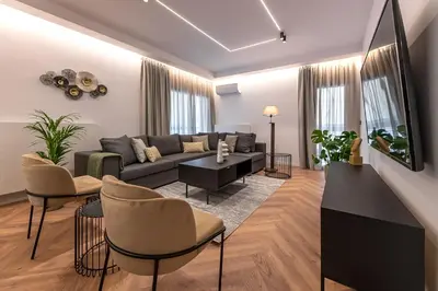 a living room with a couch and chairs at Phaedrus Living Luxury Penthouse Ploutarchou in Athens