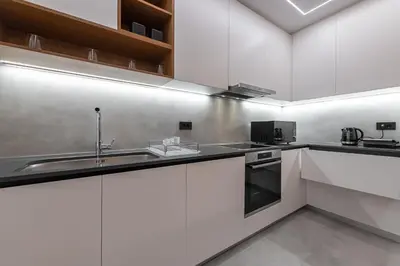 a kitchen with white cabinets and a sink at Phaedrus Living Luxury Penthouse Ploutarchou in Athens