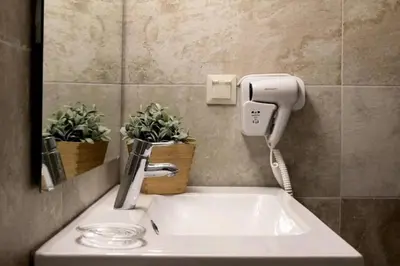 a bathroom sink with a phone and plants on it at Stylish apartment in Acropolis in Athens