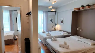 a bedroom with two beds with towels on them at Stylish apartment in Acropolis in Athens