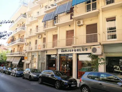 a row of cars parked in front of a building at Stylish apartment in Acropolis in Athens