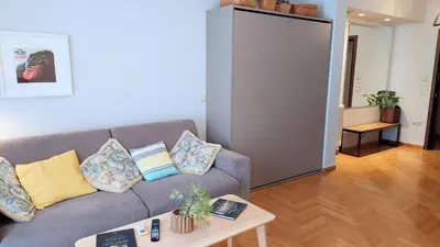a living room with a couch and a table at Stylish apartment in Acropolis in Athens