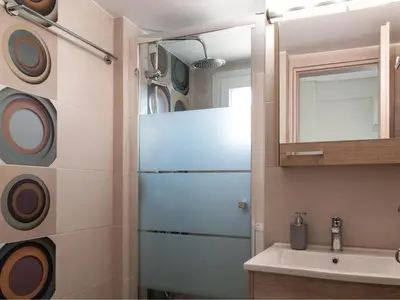 a bathroom with a sink and a refrigerator at Konstantinou Apartment - smart & roof top terrace in Athens