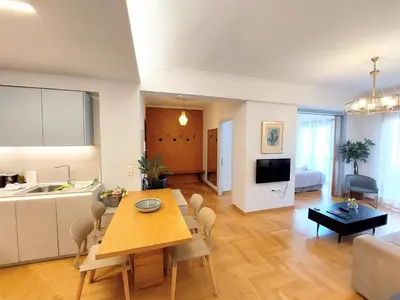 a living room with a dining table and a kitchen at Elegant apartment in Acropolis in Athens