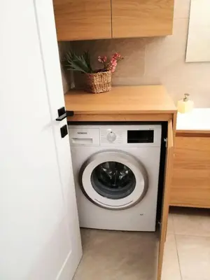 a washing machine in a kitchen with a counter at Elegant apartment in Acropolis in Athens