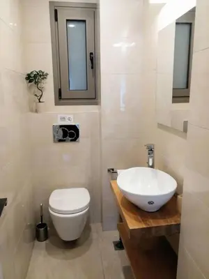 a bathroom with a white toilet and a sink at Elegant apartment in Acropolis in Athens